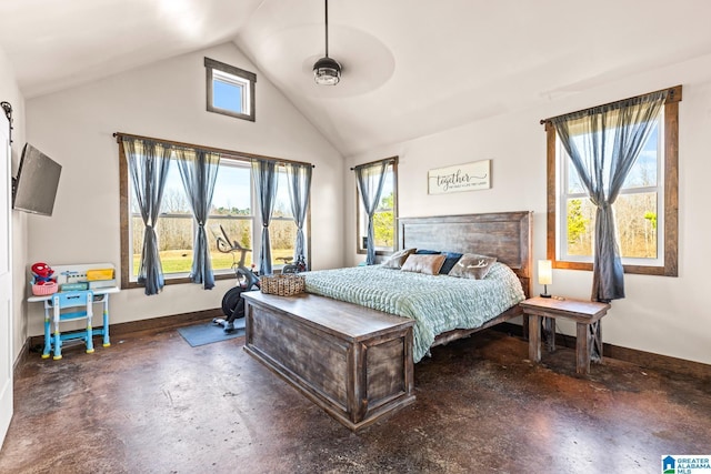 bedroom with lofted ceiling, baseboards, and concrete flooring