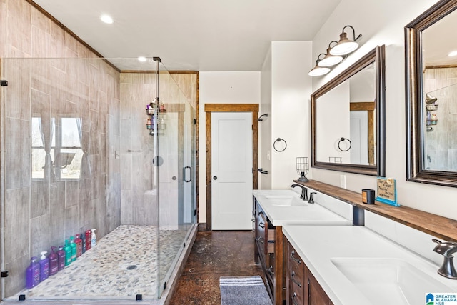 bathroom featuring double vanity, recessed lighting, a shower stall, and a sink