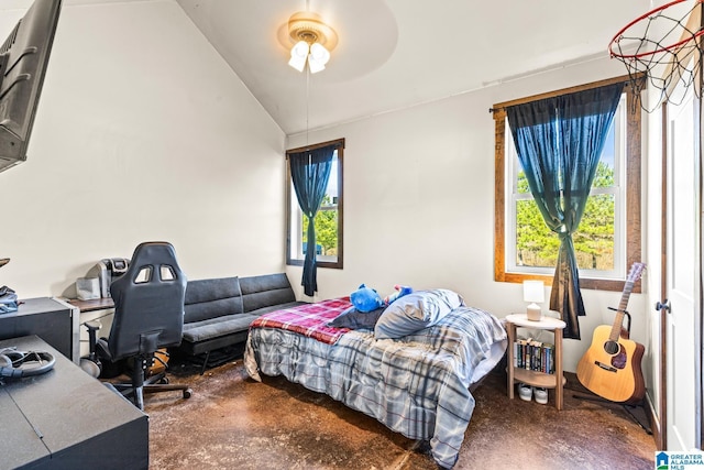 bedroom featuring lofted ceiling, concrete floors, and a ceiling fan