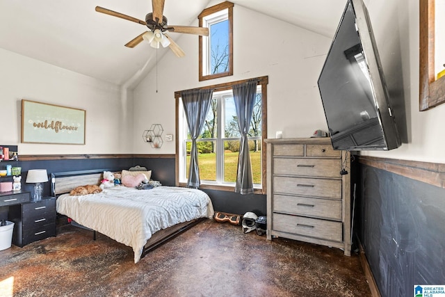 bedroom featuring high vaulted ceiling, concrete flooring, ceiling fan, and wainscoting