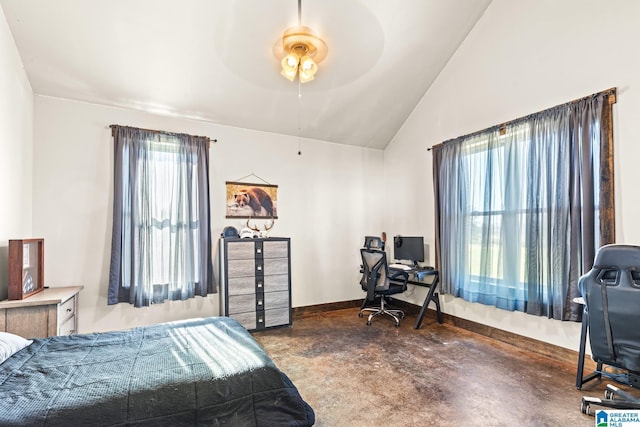 bedroom with lofted ceiling, baseboards, and concrete flooring