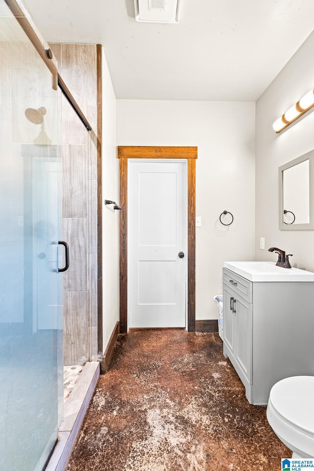 bathroom featuring a stall shower, vanity, and baseboards