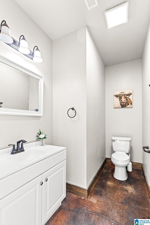 bathroom featuring visible vents, toilet, vanity, and baseboards