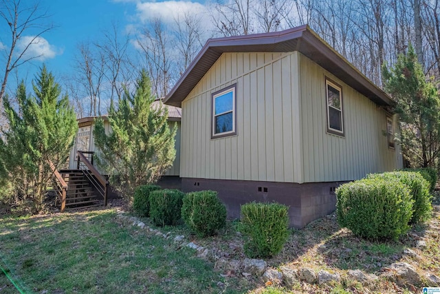 view of property exterior featuring crawl space and stairs