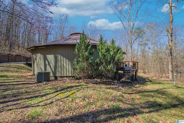 exterior space featuring a deck, an outdoor structure, fence, stairs, and a yard