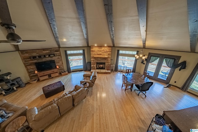 living area featuring a fireplace, wood finished floors, and a healthy amount of sunlight