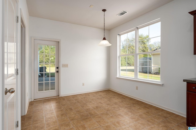 unfurnished dining area with visible vents and baseboards