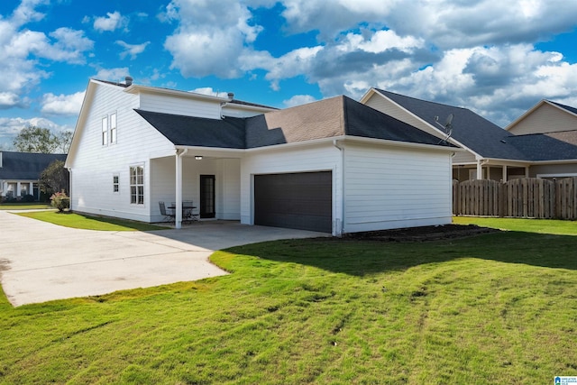 view of front of property with a garage, fence, driveway, and a front lawn