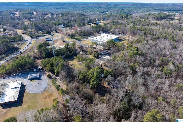 drone / aerial view featuring a forest view