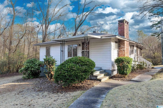 view of side of home featuring a chimney