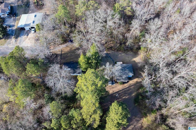 birds eye view of property with a view of trees