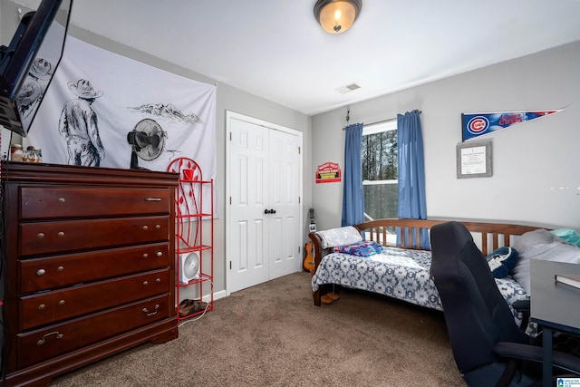 carpeted bedroom with visible vents and a closet