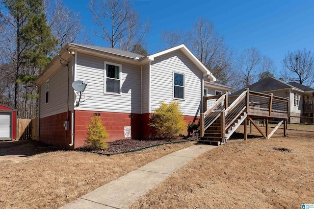 view of front facade with a deck and stairs