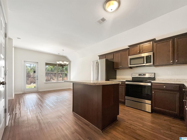 kitchen with dark wood-style flooring, stainless steel appliances, light countertops, visible vents, and dark brown cabinetry