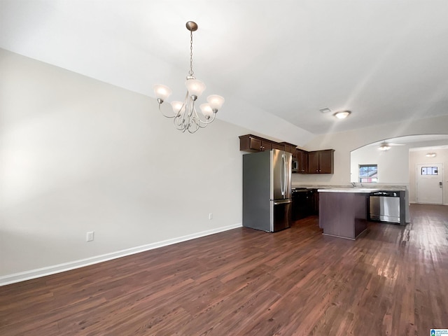 kitchen featuring dark brown cabinetry, arched walkways, open floor plan, stainless steel appliances, and light countertops