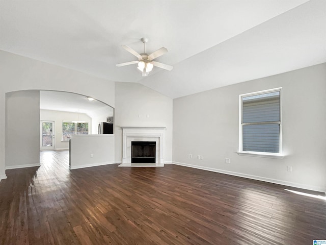 unfurnished living room with vaulted ceiling, dark wood-style flooring, a fireplace, and ceiling fan