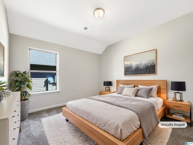 bedroom featuring vaulted ceiling, carpet, visible vents, and baseboards