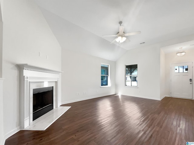 unfurnished living room featuring dark wood-style flooring, a fireplace, lofted ceiling, ceiling fan, and baseboards