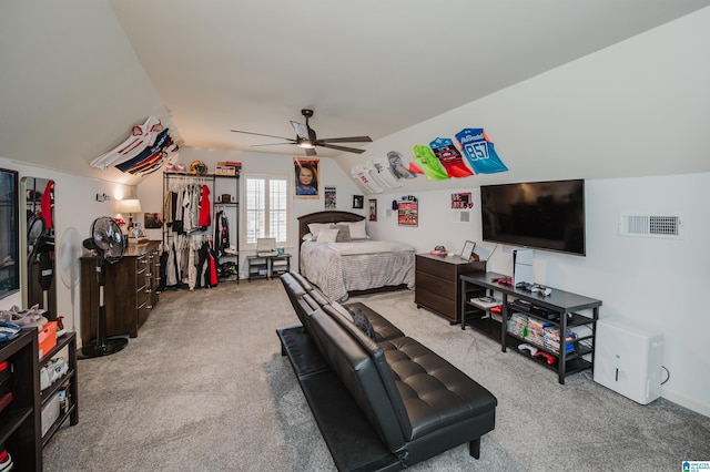 bedroom with a ceiling fan, vaulted ceiling, carpet, and visible vents