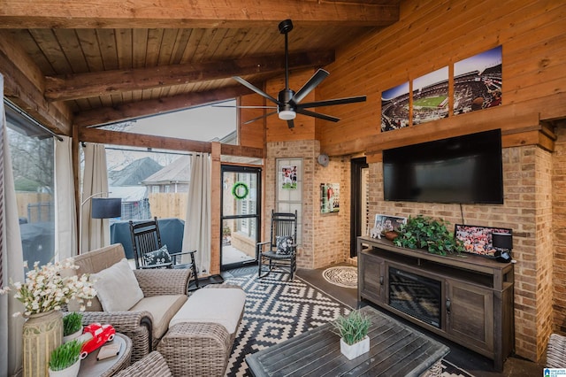 carpeted living area with ceiling fan, a healthy amount of sunlight, wooden ceiling, and vaulted ceiling with beams