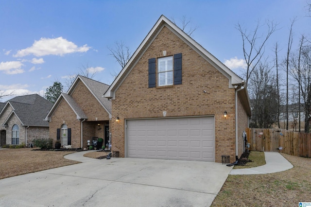 traditional-style home with a garage, fence, brick siding, and driveway