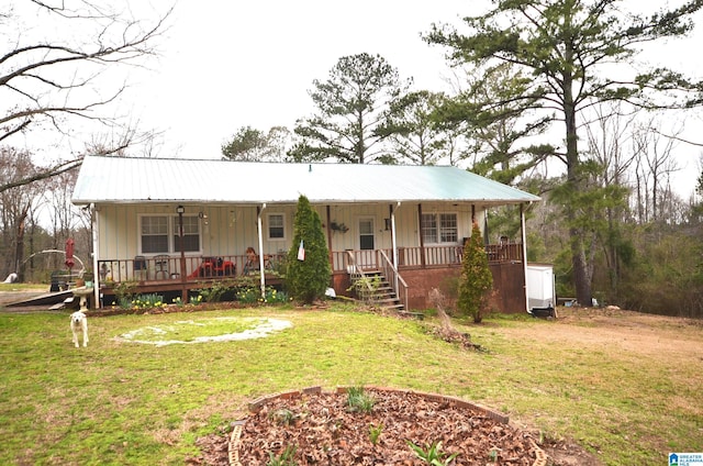 view of front of home with metal roof, a porch, board and batten siding, and a front yard