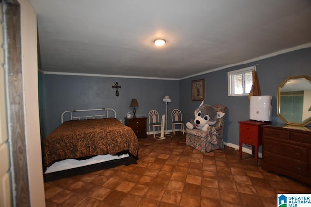 bedroom with ornamental molding and baseboards