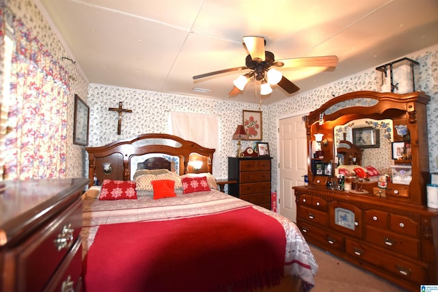 carpeted bedroom featuring a ceiling fan, visible vents, and wallpapered walls