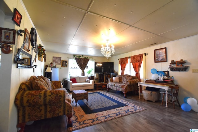 living room with wood finished floors and a notable chandelier