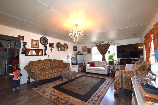 living room with wood finished floors and a notable chandelier