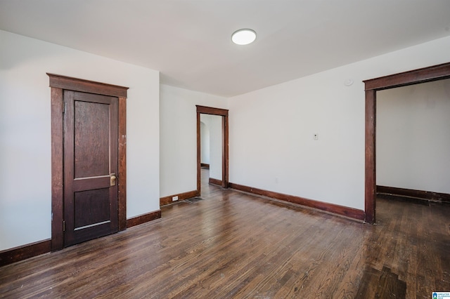 unfurnished bedroom featuring a closet, baseboards, and wood finished floors