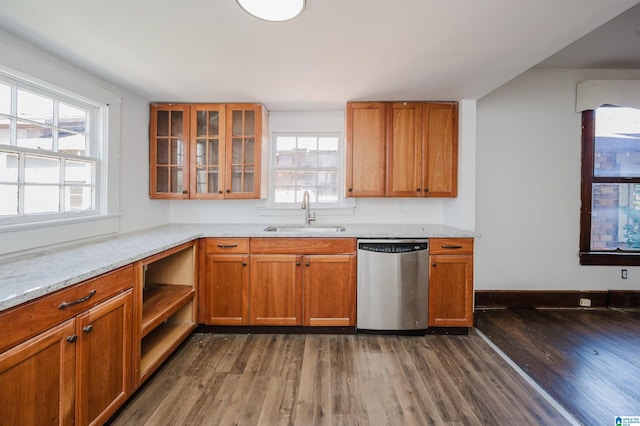 kitchen featuring a sink, brown cabinets, dishwasher, dark wood finished floors, and glass insert cabinets