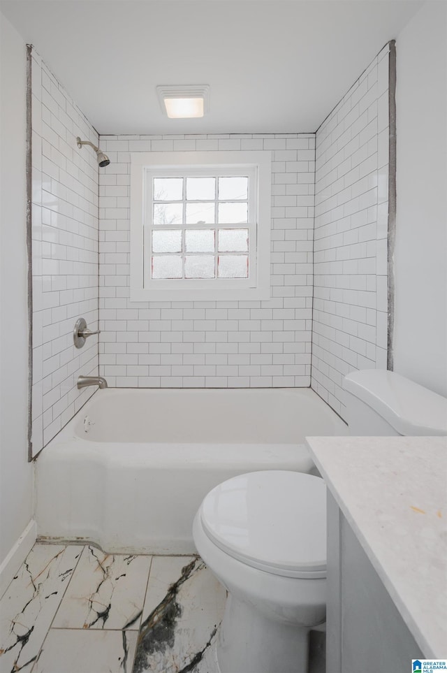 bathroom featuring marble finish floor, bathtub / shower combination, vanity, and toilet