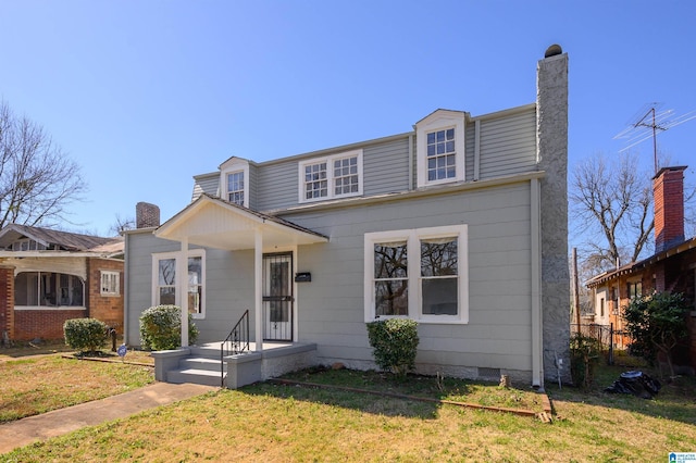 view of front of property with crawl space, a chimney, and a front yard