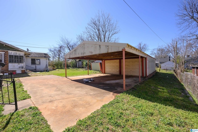 exterior space featuring entry steps, a detached garage, and fence