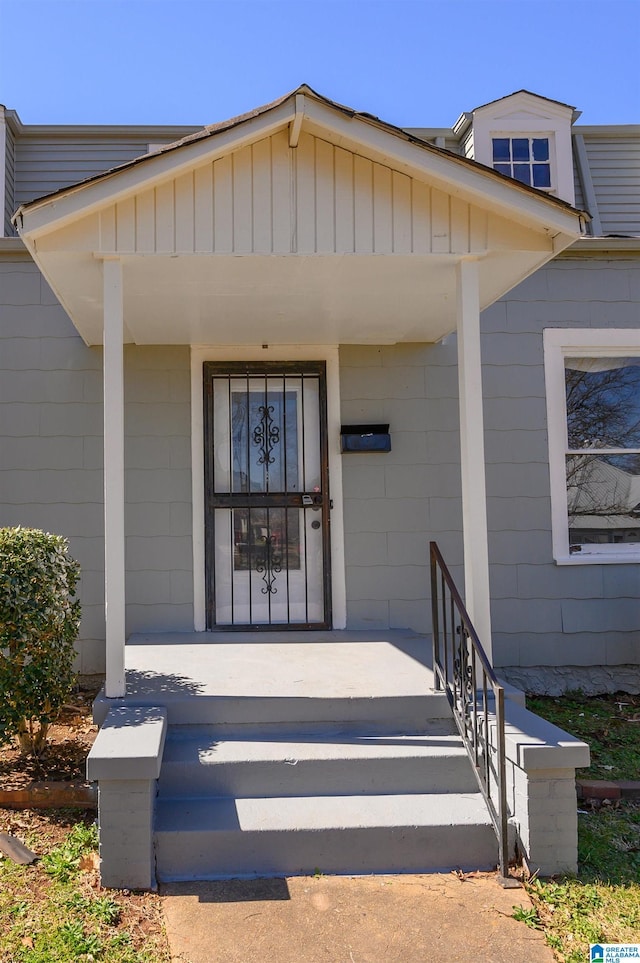 view of exterior entry with a porch