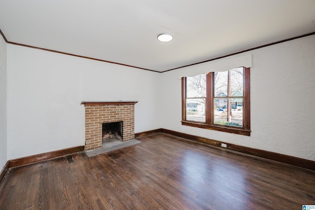 unfurnished living room featuring a fireplace, baseboards, wood finished floors, and ornamental molding