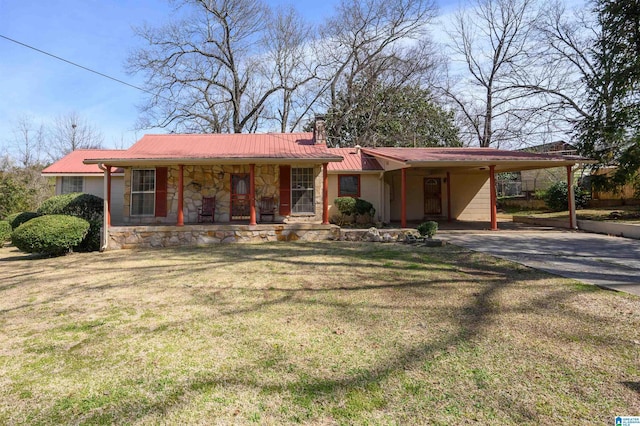 ranch-style home with metal roof, an attached carport, stone siding, a front lawn, and a chimney