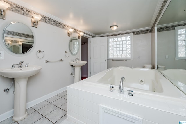 bathroom with baseboards, a tub with jets, tile patterned floors, and crown molding