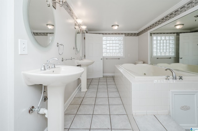 full bath featuring tile patterned flooring, two sinks, crown molding, and a jetted tub