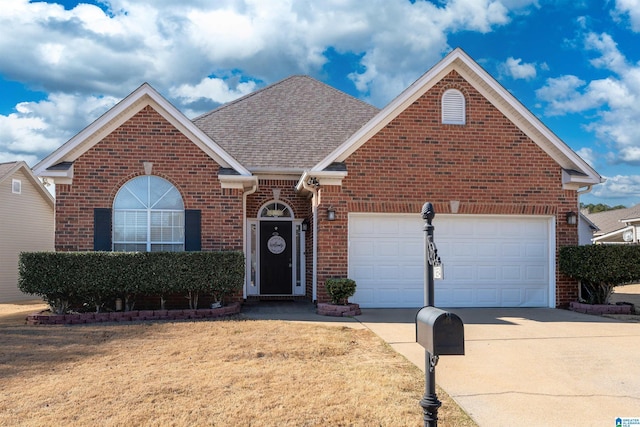 view of front facade with brick siding, driveway, an attached garage, and roof with shingles