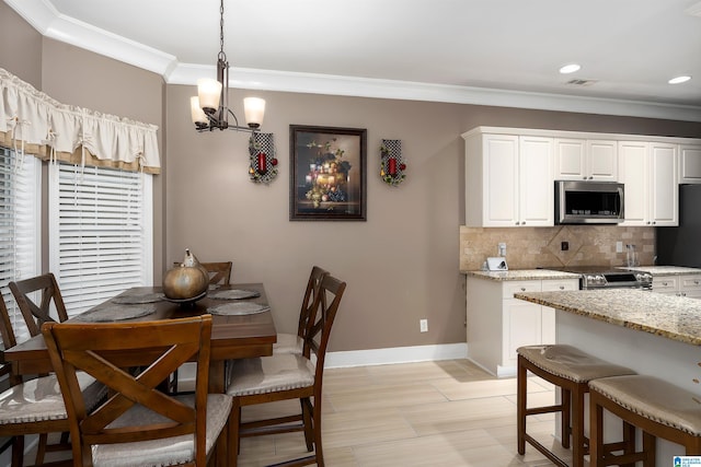 dining area featuring baseboards, visible vents, crown molding, a chandelier, and recessed lighting