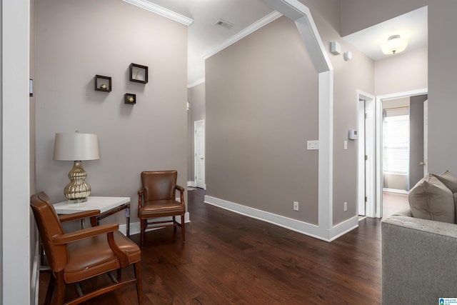 living area featuring arched walkways, crown molding, dark wood finished floors, and baseboards