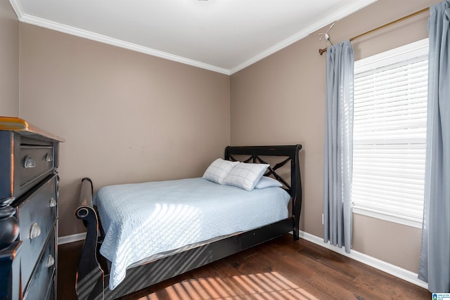 bedroom featuring ornamental molding, dark wood finished floors, and baseboards