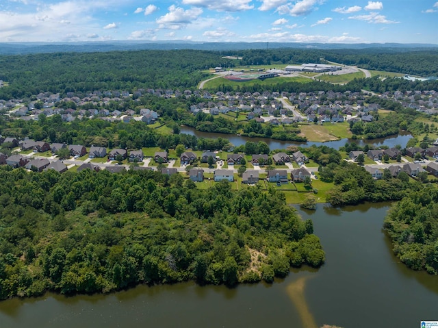 bird's eye view with a water view, a residential view, and a view of trees