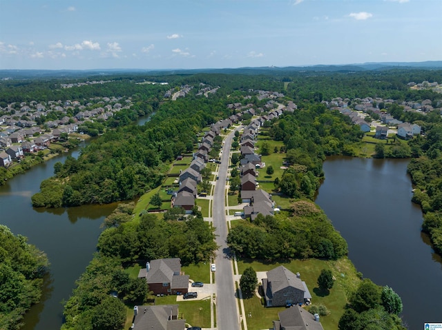 drone / aerial view featuring a water view and a residential view