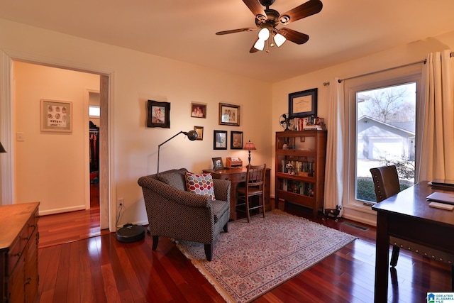 home office featuring hardwood / wood-style flooring, visible vents, and a ceiling fan