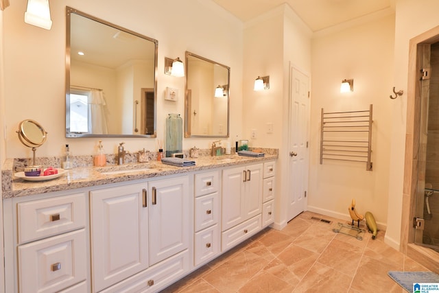 bathroom featuring double vanity, ornamental molding, and a sink