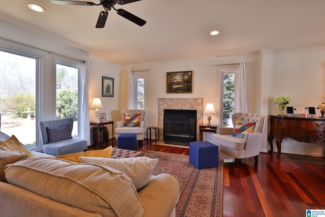 living room featuring plenty of natural light, wood-type flooring, and ornamental molding