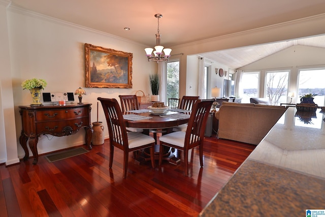 dining room with plenty of natural light, dark wood finished floors, and an inviting chandelier